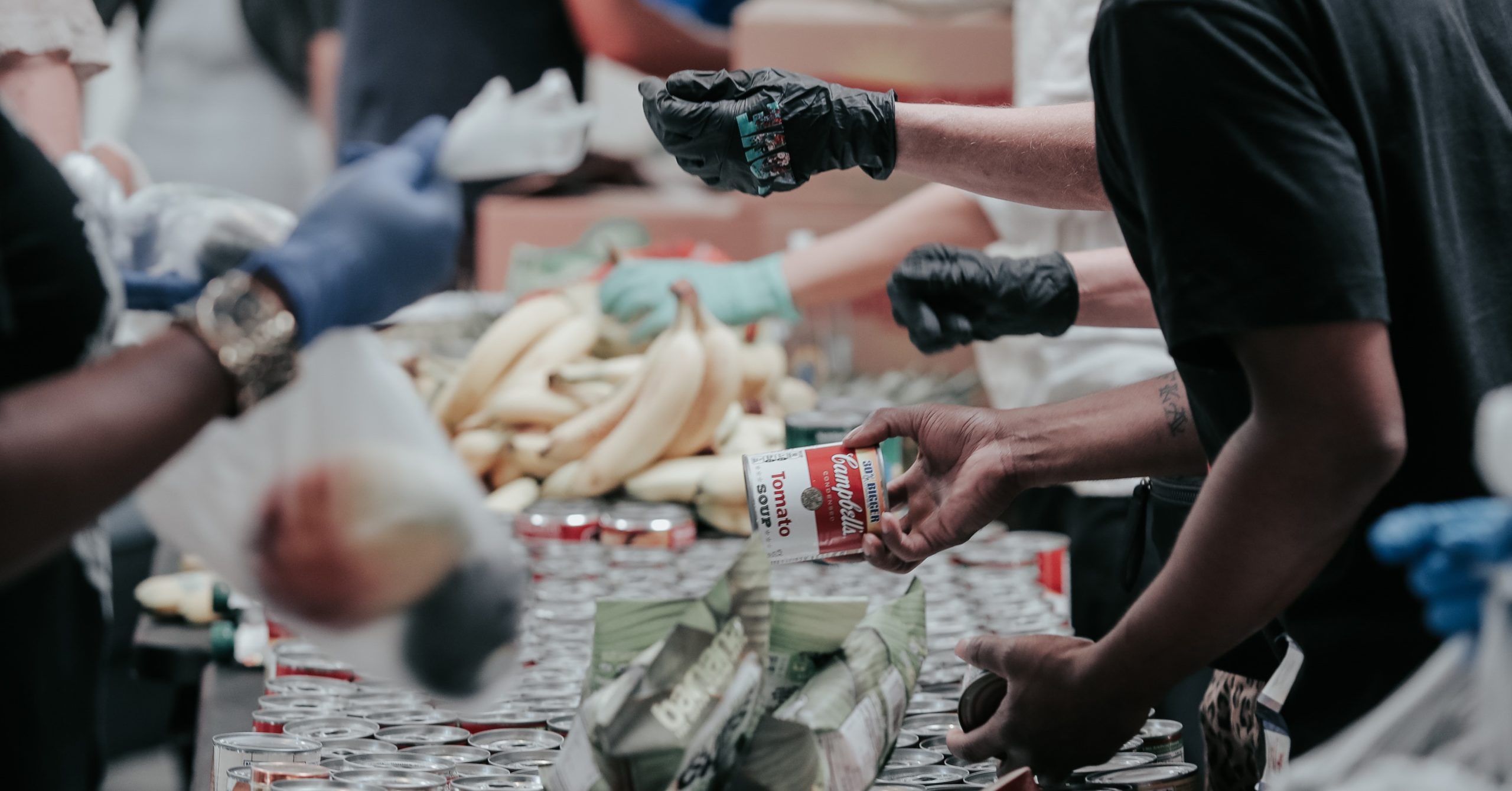 People sorting canned food for donations at a food bank