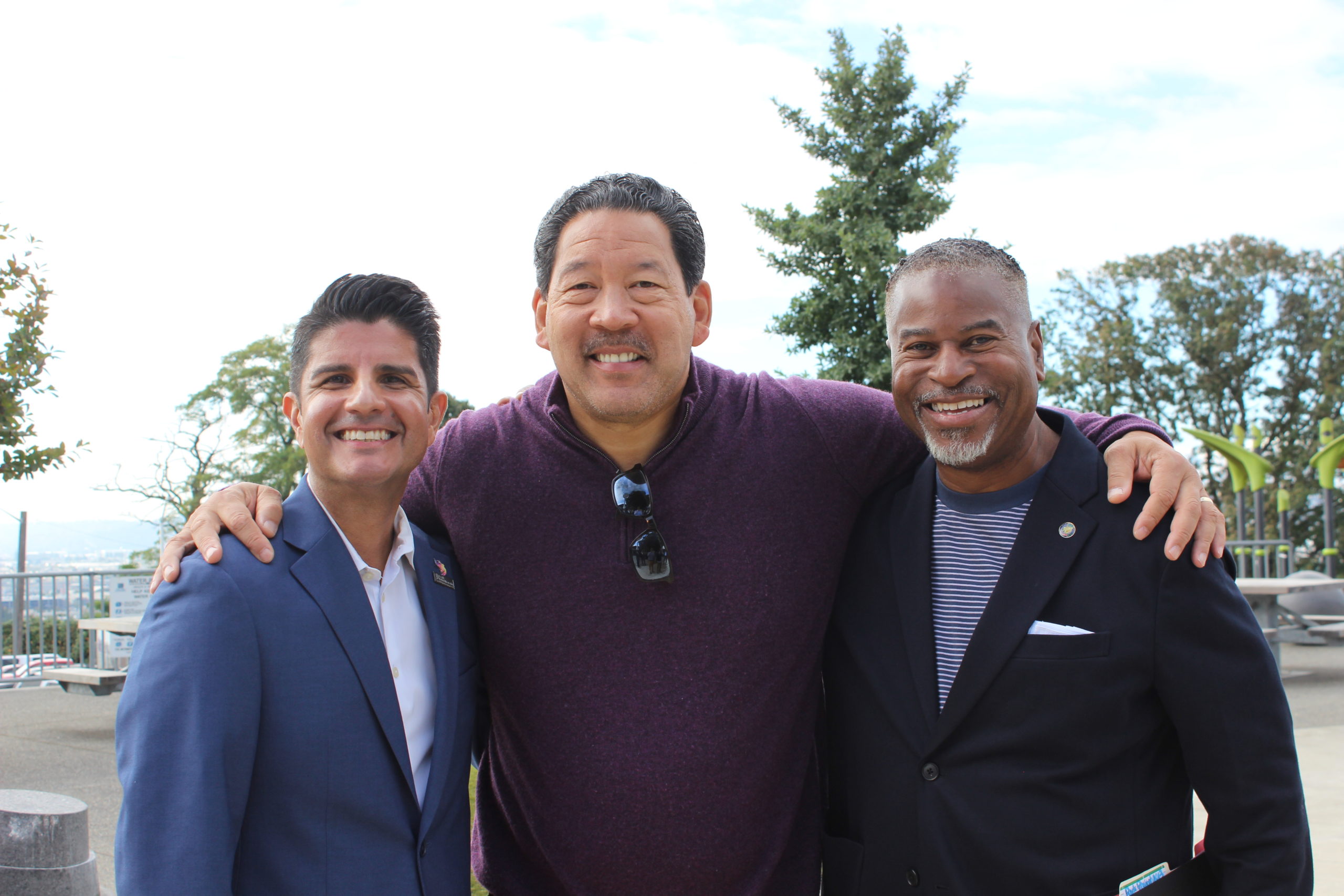 AP Diaz (left), Mayor Harrell (center) and Christopher Williams (right) pose for a photo.