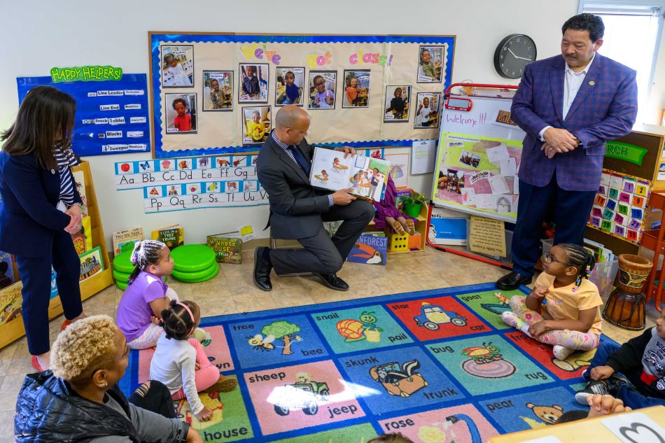 Director Chapelle reads a children's books to preschoolers.