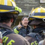 Mayor Harrell speaking to firefighter recruits in full gear