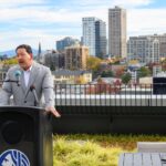 Mayor Harrell talks in front of downtown Seattle.