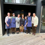 Mayor Harrell with Donna Moodie and staff outside of Marjorie's restaurant.