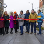 Mayor Harrell and community members cut ribbon at celebration event in Pioneer Square