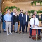 Mayor Harrell signs Downtown Activation Plan legislation with leaders and community stakeholders behind him.