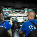 CARE community crisis responders in vehicle wearing blue polos