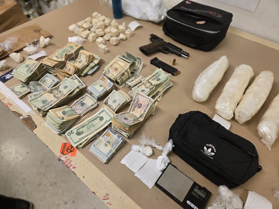 Photo of drugs, cash, and a gun seized as evidence